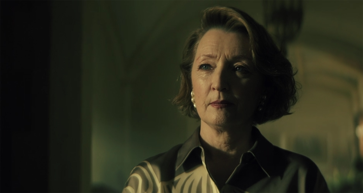 Lesley Manville looks sternfully.