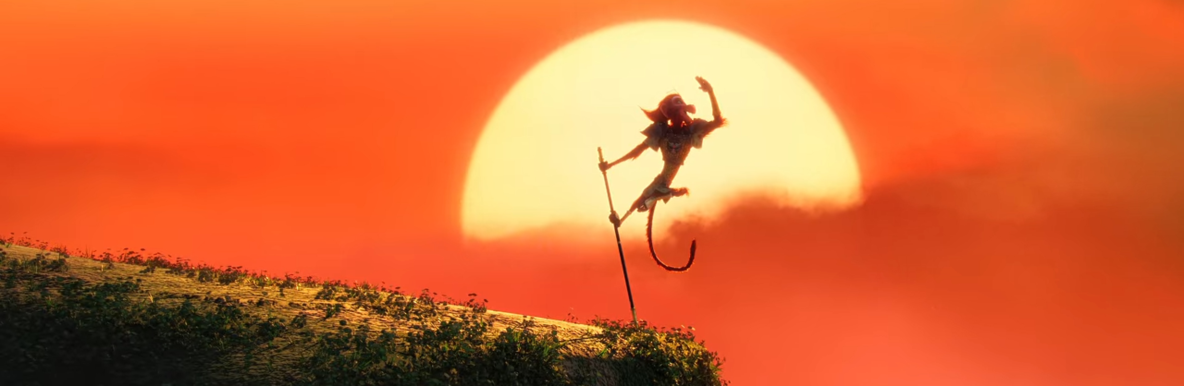 The Monkey King poses in front of a setting sun.