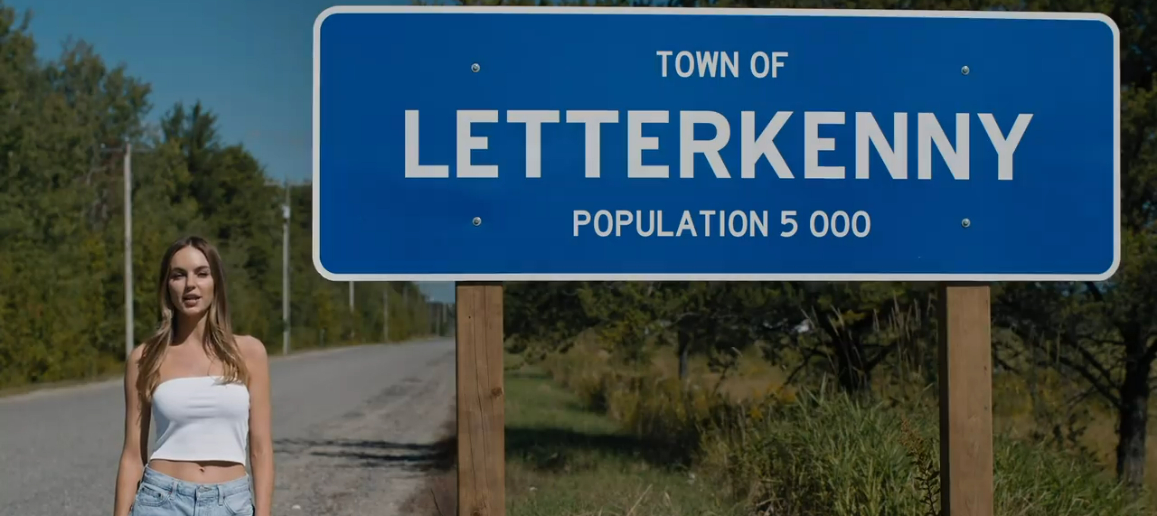 Katy talks in front of the Letterkenny sign.