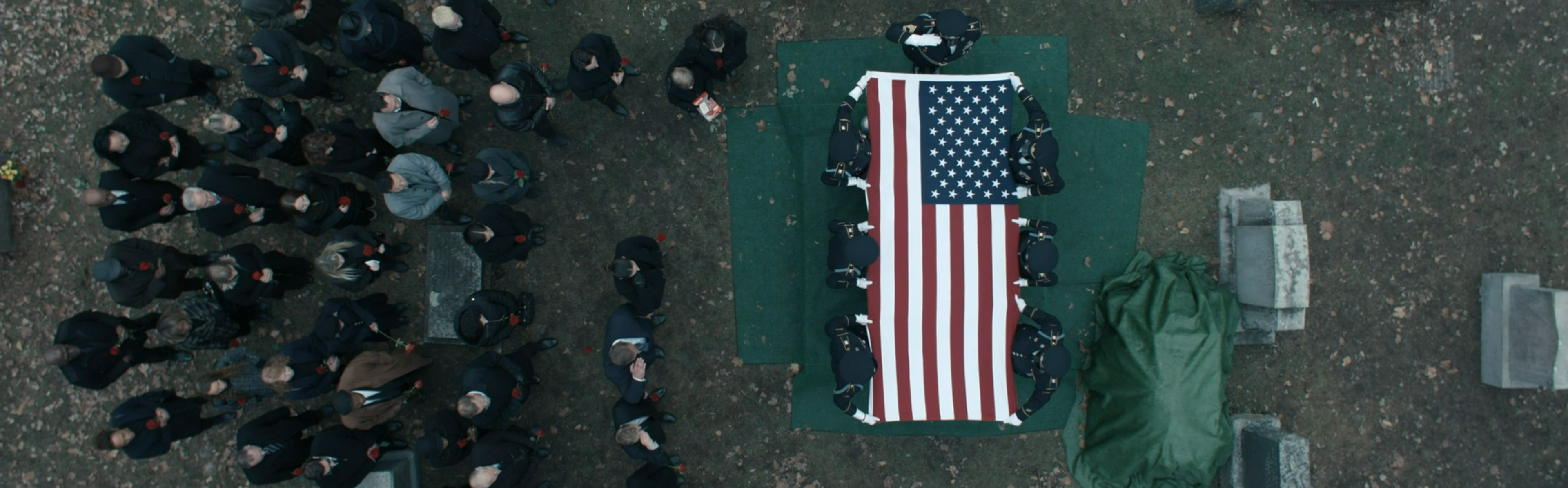 The American flag over a coffin.
